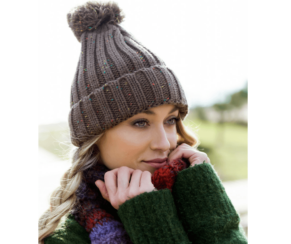 Woman in knitted beanie, scarf and jumper